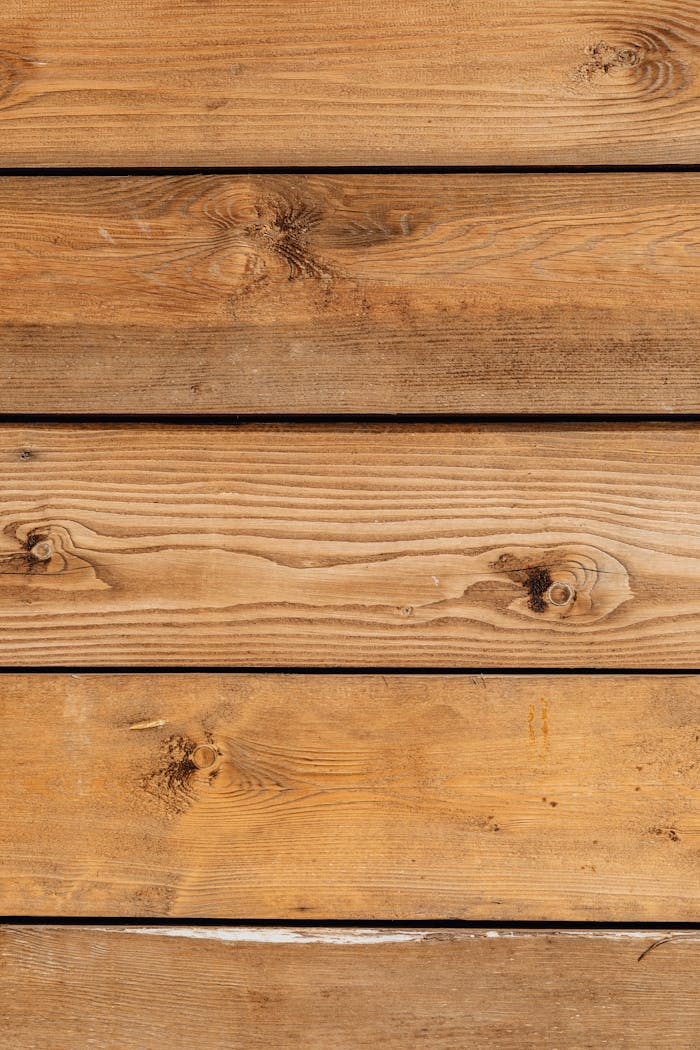 vision Close-up of natural wood planks with distinct wood grain patterns and knots, ideal for design backgrounds.